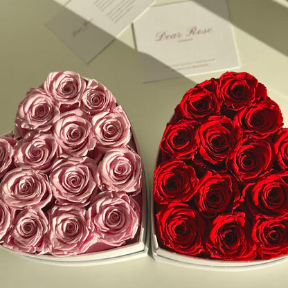 Heart-shaped boxes filled with pink and red roses on a light background